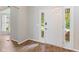 Inviting entryway with wood-look tile flooring, complemented by a bright white door and sidelight windows at 12043 Searay Dr, Indianapolis, IN 46236