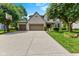 Charming two-story home featuring a spacious driveway, well-maintained lawn, and a three-car garage at 12043 Searay Dr, Indianapolis, IN 46236
