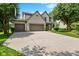 Charming two-story home featuring a spacious driveway, well-maintained lawn, and a three-car garage at 12043 Searay Dr, Indianapolis, IN 46236