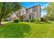Beautifully landscaped front yard with lush green grass and well-maintained shrubs complementing the inviting home exterior at 12043 Searay Dr, Indianapolis, IN 46236