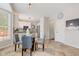 Eat-in kitchen featuring a glass table, neutral tile floor, and access to the main kitchen area at 12043 Searay Dr, Indianapolis, IN 46236