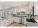 Bright kitchen featuring granite countertops, stainless steel appliances, and a view of the backyard at 12043 Searay Dr, Indianapolis, IN 46236