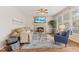 Comfortable living room area with fireplace, neutral colors and plenty of light at 12043 Searay Dr, Indianapolis, IN 46236