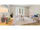 Bright living room featuring a bay window, neutral decor, and wood-look tile flooring for a cozy atmosphere at 12043 Searay Dr, Indianapolis, IN 46236