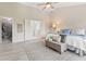 A serene main bedroom features a sitting area, ensuite bathroom, and walk-in closet at 12043 Searay Dr, Indianapolis, IN 46236