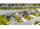 Aerial view of waterfront houses and community with manicured lawns and mature trees at 12105 Fall Ct, Indianapolis, IN 46229