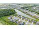 Aerial view of homes in a community with a beautiful pond and lush green landscape at 12105 Fall Ct, Indianapolis, IN 46229