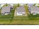 Aerial view of a backyard with a fenced-in yard and patio overlooking a tranquil body of water at 12105 Fall Ct, Indianapolis, IN 46229