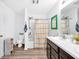 Bright bathroom with shower, large mirror, and vanity with storage at 12105 Fall Ct, Indianapolis, IN 46229
