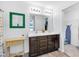 Bathroom featuring double vanity with dark cabinets, framed mirror, and ample lighting at 12105 Fall Ct, Indianapolis, IN 46229