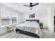 Bright bedroom with ceiling fan, and large window overlooking the neighborhood at 12105 Fall Ct, Indianapolis, IN 46229