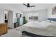 Comfortable bedroom with ceiling fan, dresser, and bright window overlooking the neighborhood at 12105 Fall Ct, Indianapolis, IN 46229