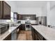 Modern kitchen featuring stainless steel appliances, granite countertops, and dark wood cabinetry at 12105 Fall Ct, Indianapolis, IN 46229
