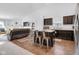 Open-concept kitchen featuring a center island with seating, dark cabinetry, and stainless steel appliances at 12105 Fall Ct, Indianapolis, IN 46229