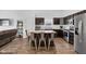 Modern kitchen featuring dark cabinets, an island with seating, and hardwood floors at 12105 Fall Ct, Indianapolis, IN 46229