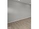 A bright room features smooth gray walls and wood look vinyl flooring at 12500 Morning Ridge Way, Noblesville, IN 46060