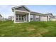 A home's rear elevation featuring green grass and blue siding at 12500 Morning Ridge Way, Noblesville, IN 46060