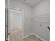 A laundry room with vinyl wood look flooring and wire shelving at 12500 Morning Ridge Way, Noblesville, IN 46060