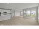 Bright, open-concept living room featuring modern flooring and large windows for ample natural light at 12500 Morning Ridge Way, Noblesville, IN 46060