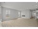 Spacious living room with fireplace, neutral paint, and plenty of natural light at 12500 Morning Ridge Way, Noblesville, IN 46060