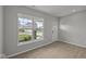 Bright living room featuring a large window overlooking a well-maintained front yard and stylish flooring at 12500 Morning Ridge Way, Noblesville, IN 46060