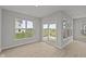A sun-filled room with sliding glass doors, and large windows offering a great view of the yard at 12500 Morning Ridge Way, Noblesville, IN 46060