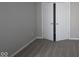 This bedroom with neutral colored walls leads to a closet with double doors and carpeted floors at 12516 Morning Ridge Way, Noblesville, IN 46060
