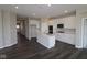Spacious kitchen with white cabinets, stainless steel appliances, and a center island, seamlessly flowing into adjacent living spaces at 12516 Morning Ridge Way, Noblesville, IN 46060