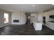 Modern kitchen boasts white cabinets, stainless steel appliances, a center island, and sleek floors that complement the open layout at 12516 Morning Ridge Way, Noblesville, IN 46060