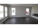 Sunlit living room featuring sleek floors, neutral walls, and a modern fireplace, complemented by large windows offering scenic views at 12516 Morning Ridge Way, Noblesville, IN 46060