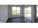 Bright sunroom features sleek floors, neutral walls, expansive windows offering a tranquil view of the outdoors, and a sliding door at 12516 Morning Ridge Way, Noblesville, IN 46060