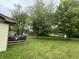 Spacious backyard with grass and trees with a view of the deck, providing a private and serene outdoor space at , Indianapolis, IN 46241