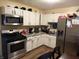 Functional kitchen with stainless steel appliances, white cabinets, and plenty of counter space for meal prep at , Indianapolis, IN 46241