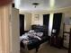 Comfortable main bedroom with large bed, neutral wall color, curtains and side table with lamp and a closet at , Indianapolis, IN 46241