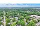 Expansive aerial view of a neighborhood with lush trees and varied architecture, near city amenities at 1338 N Parker Ave, Indianapolis, IN 46201
