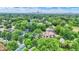 Scenic aerial view of a lush, tree-filled neighborhood with a city skyline visible in the distance at 1338 N Parker Ave, Indianapolis, IN 46201
