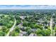 Scenic aerial view of a tree-covered community with varied homes and a commercial area nearby at 1338 N Parker Ave, Indianapolis, IN 46201
