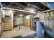 Basement featuring the hot water heater, utilities, and the unfinished floors and walls at 1338 N Parker Ave, Indianapolis, IN 46201