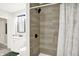 Bathroom boasts a marble vanity, shower with a tiled surround, and a modern mirror at 1338 N Parker Ave, Indianapolis, IN 46201