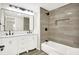 Modern bathroom featuring double vanity, sleek fixtures, and tiled shower with built-in niche at 1338 N Parker Ave, Indianapolis, IN 46201