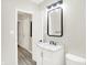 Bathroom showcasing a white vanity with marble top and wood-look flooring at 1338 N Parker Ave, Indianapolis, IN 46201