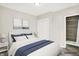 Staged bedroom showing white and blue decor with an ensuite at 1338 N Parker Ave, Indianapolis, IN 46201