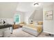 Tastefully staged bedroom with a bed, armchair, and desk arrangement creates a cozy and functional living space at 1338 N Parker Ave, Indianapolis, IN 46201