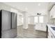Open floor plan shows the stainless refrigerator, island, and staircase at 1338 N Parker Ave, Indianapolis, IN 46201