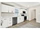 Modern kitchen featuring white cabinets, stainless steel appliances, and beautiful wood-look flooring at 1338 N Parker Ave, Indianapolis, IN 46201