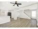 Spacious living room featuring wood-look floors, a staircase, and plenty of natural light at 1338 N Parker Ave, Indianapolis, IN 46201