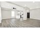 Open concept living room featuring wood-look floors, modern lighting, and a view into the kitchen at 1338 N Parker Ave, Indianapolis, IN 46201