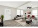 Virtually staged living room showcasing neutral tones, modern furniture, and ample natural light at 1338 N Parker Ave, Indianapolis, IN 46201