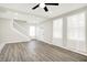 Bright, open-concept living room featuring wood-look floors, modern lighting, and a staircase at 1338 N Parker Ave, Indianapolis, IN 46201
