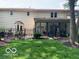 Spacious backyard with a black metal fence and an outdoor patio seating area at 1419 Dominion Dr, Zionsville, IN 46077